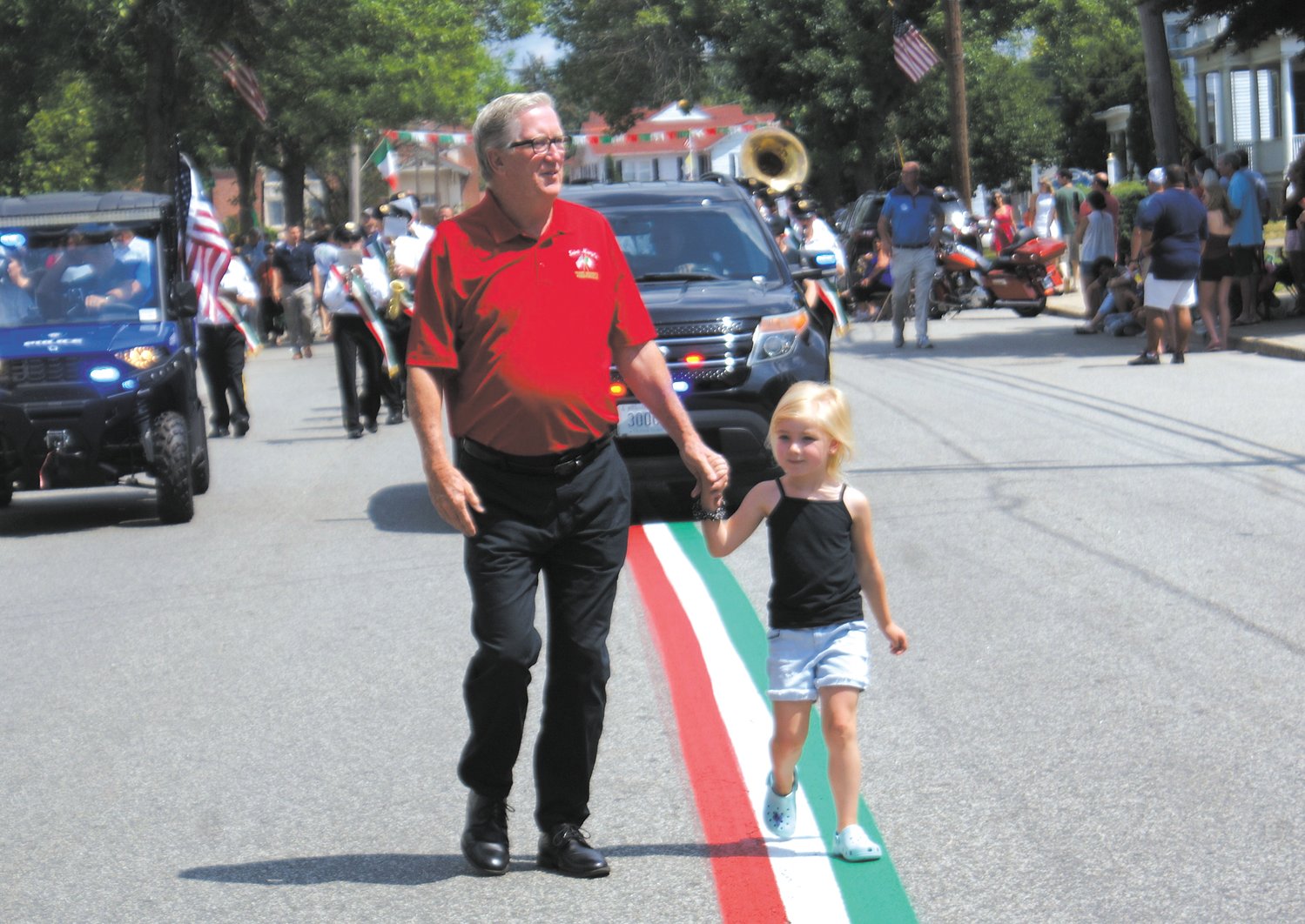 GRANFATHER AND GRANDDAUGHTER: Mayor Ken Hopkins marches in the St. Mary’s Feast Processional with his granddaughter Chloe Shackleford, 5. This was Chloe’s first time marching in the processional with her “Pa.” (Photo courtesy Steve Popiel)